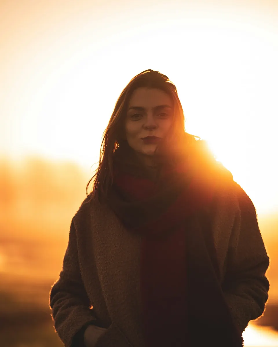 Woman backlit by golden sunlight
