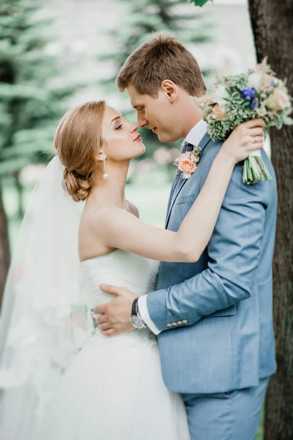 Bride and groom among the trees
